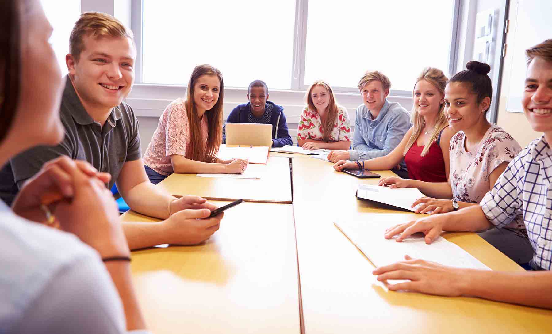 diverse group of students sitting at table