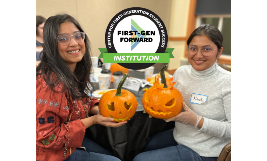 Two students holding carved pumpkins