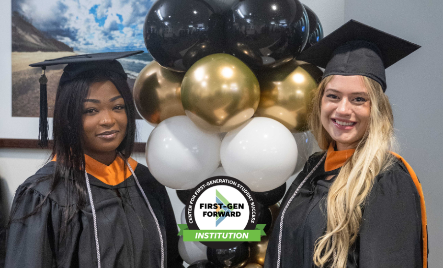 Two graduates in their cap and gown at Purdue University Northwest