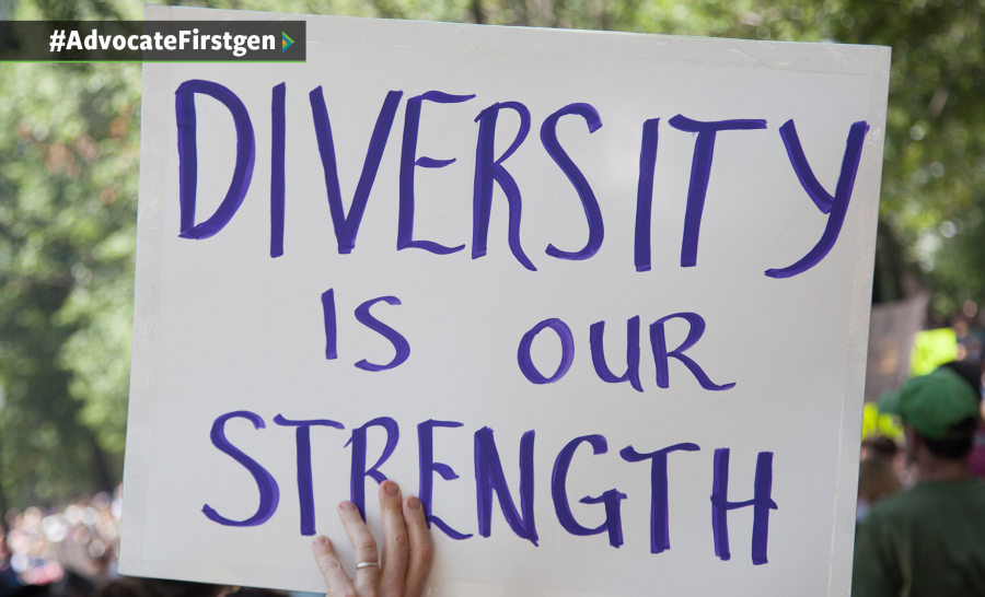 Hand holding up with sign with purple handwritten text reading 