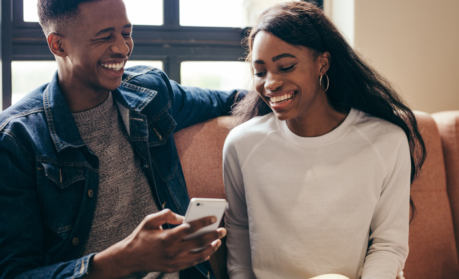 Black Students Laughing at Phone