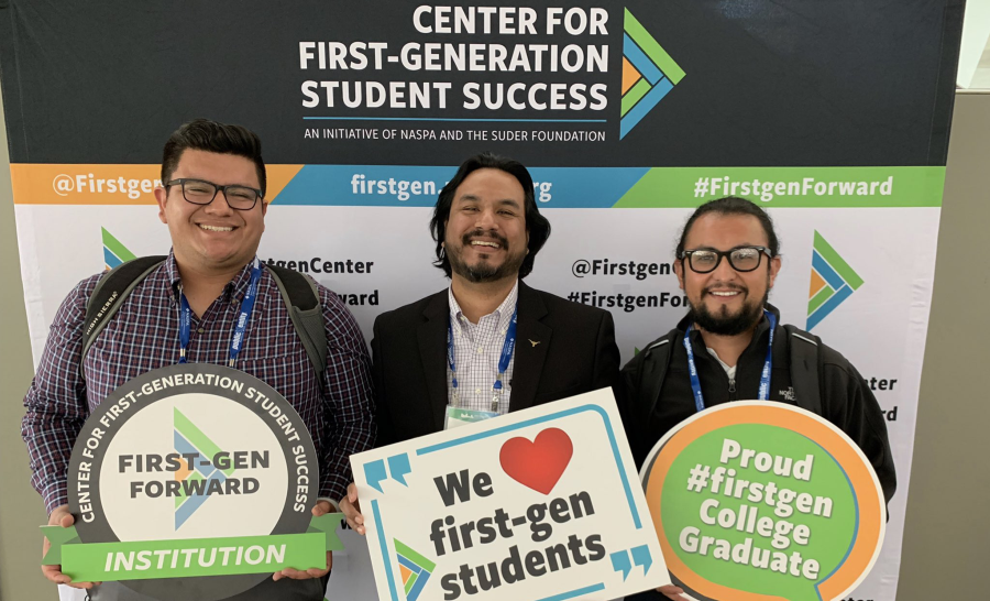 Group of staff posing in front of Center for First-generation Student Success Step and Repeat