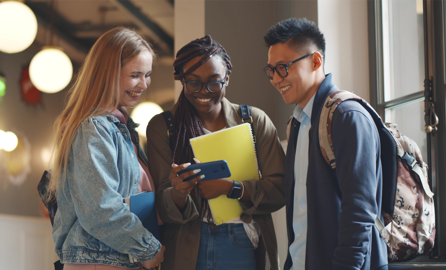 Diverse student group watching video on cell phone