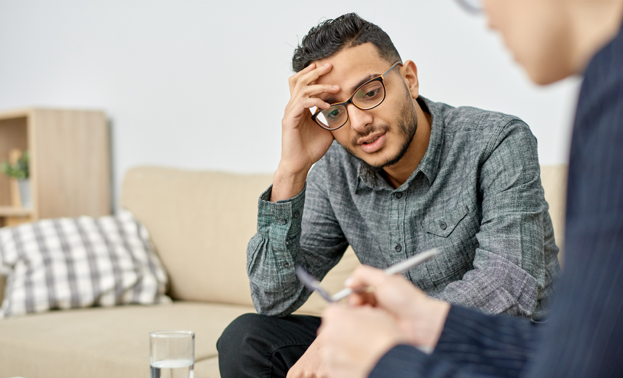 Diverse student with white counselor mental health stress