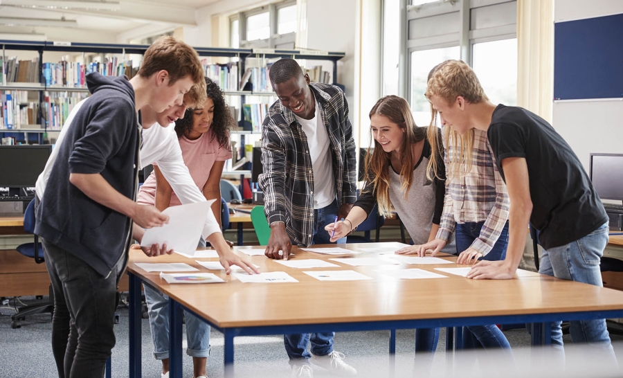 Group of diverse students working at table
