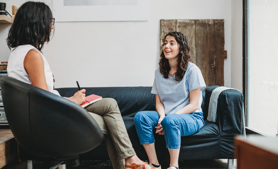 Happy female student talking to female counselor