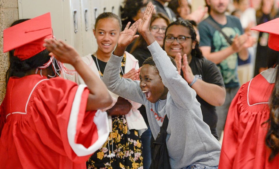 Graduates high five