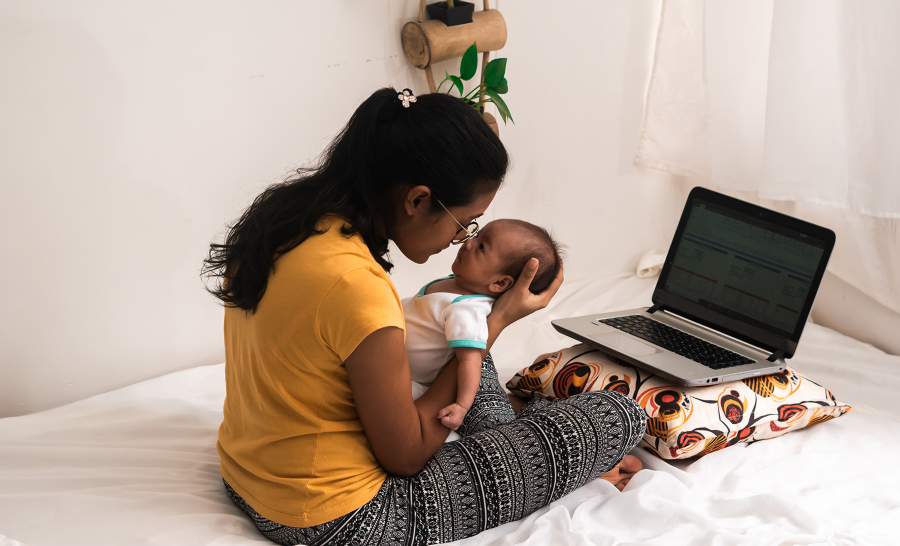Latin mother with baby and laptop