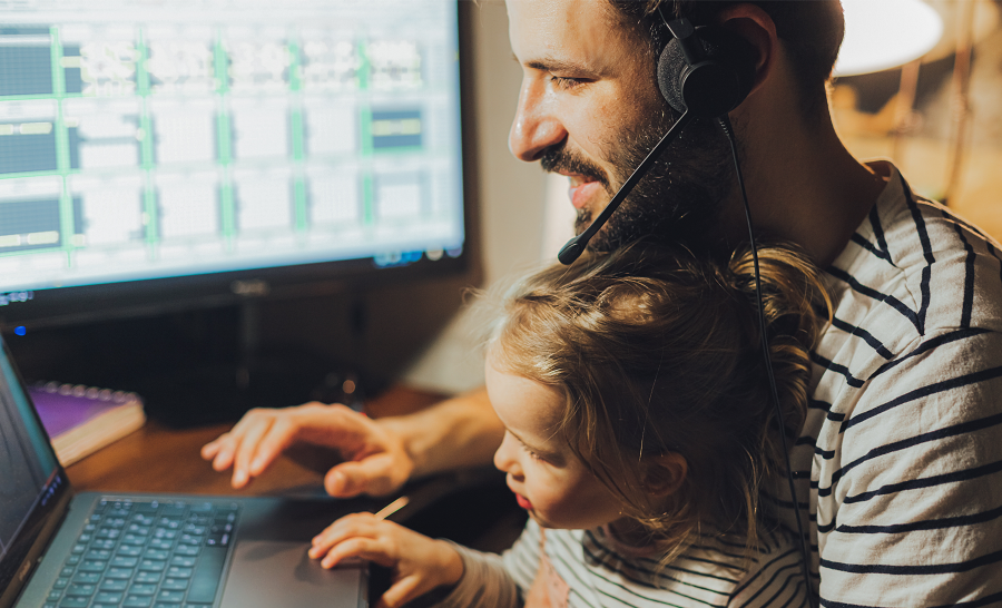 Student parent father working on laptop with daughter