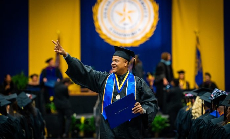 TAMUC graduate in cap and gown