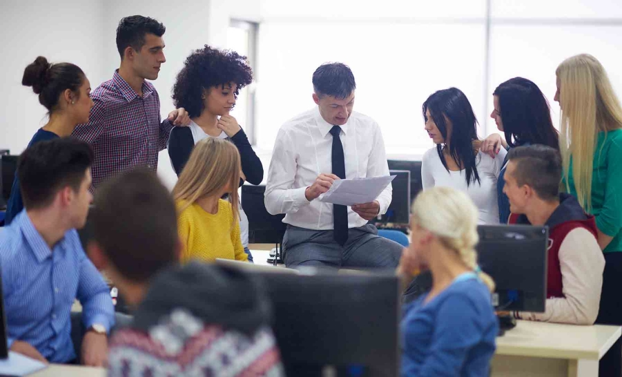 students in classroom standing with teacher