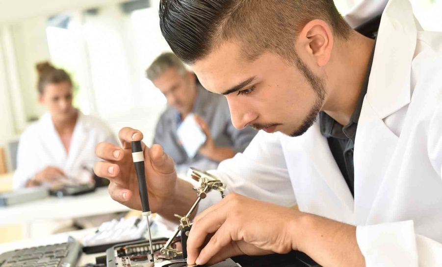 male student with tool in hand
