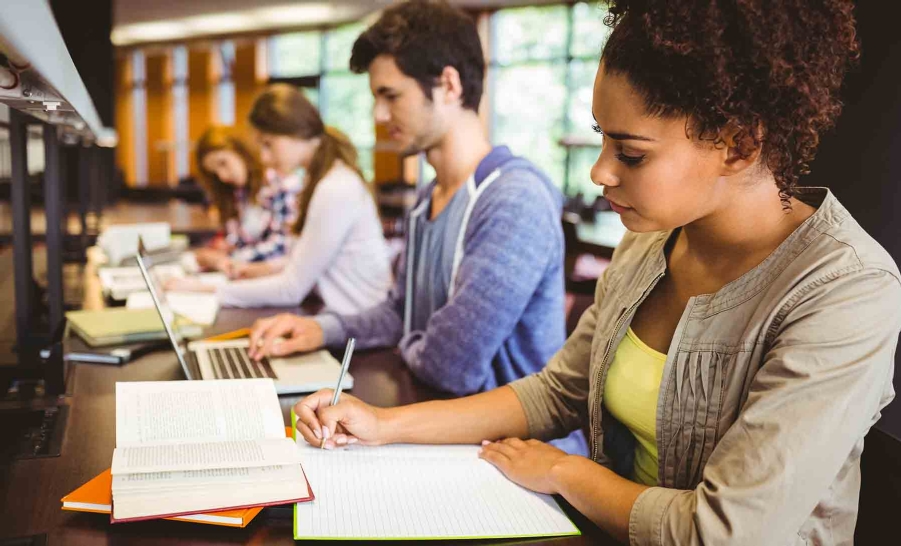 black female student writing in notebook