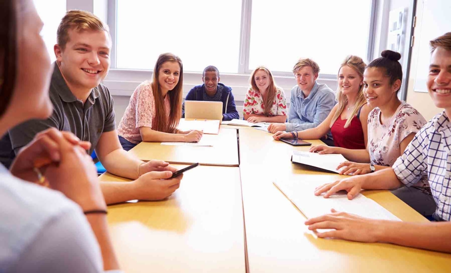 diverse group of students sitting at table