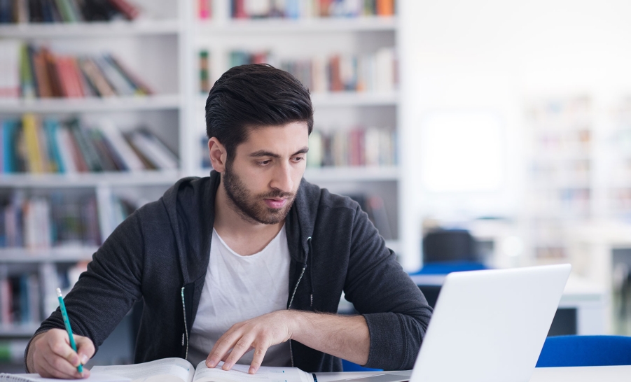  male student black zip up studying