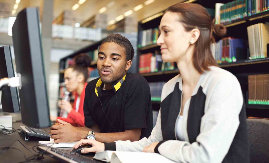 male and female students on computer