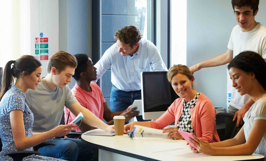 male mentor with diverse group of students