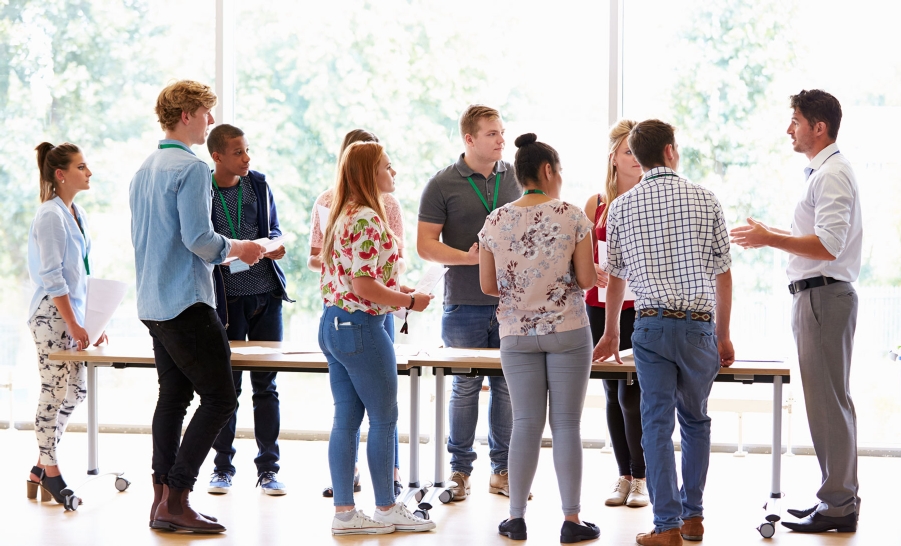 teacher talks to a group of students