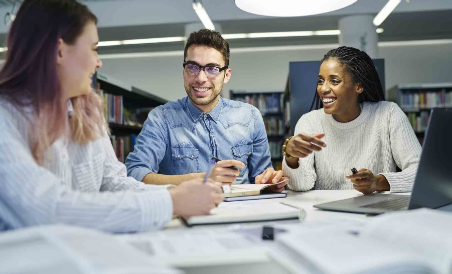 three happy students studying