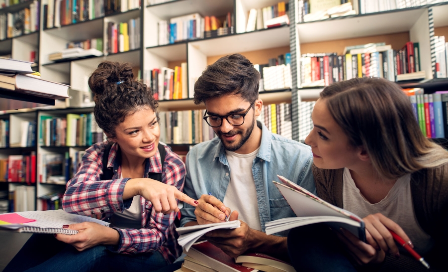 three students studying in libary